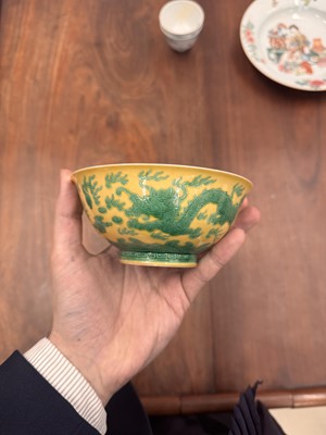 Lot 59 - A Chinese yellow-ground green-enamelled 'dragon' bowl, Qing dynasty, Tongzhi mark and of the period