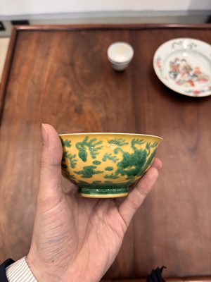 Lot 59 - A Chinese yellow-ground green-enamelled 'dragon' bowl, Qing dynasty, Tongzhi mark and of the period