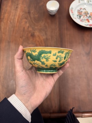 Lot 59 - A Chinese yellow-ground green-enamelled 'dragon' bowl, Qing dynasty, Tongzhi mark and of the period