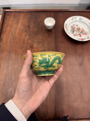 Lot 59 - A Chinese yellow-ground green-enamelled 'dragon' bowl, Qing dynasty, Tongzhi mark and of the period