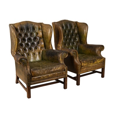 Lot 263 - A pair of late 19th/ early 20th century green leather wingback armchairs