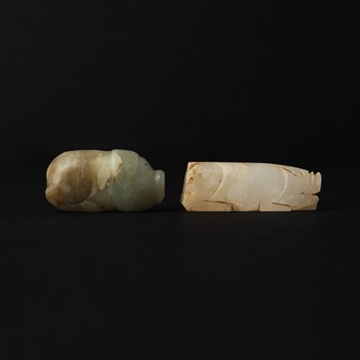 Lot 316 - Two Chinese archaic jade carvings of pigs, Han dynasty