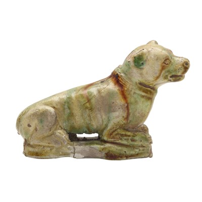 Lot 247 - A Chinese sancai-glazed pottery figure of a dog, Tang dynasty