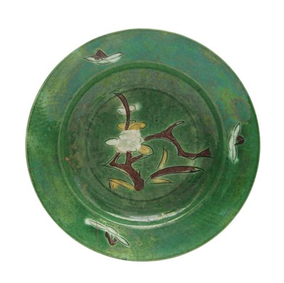 Lot 30 - A Chinese sancai-glazed biscuit 'prunus' dish, Qing dynasty, Kangxi period