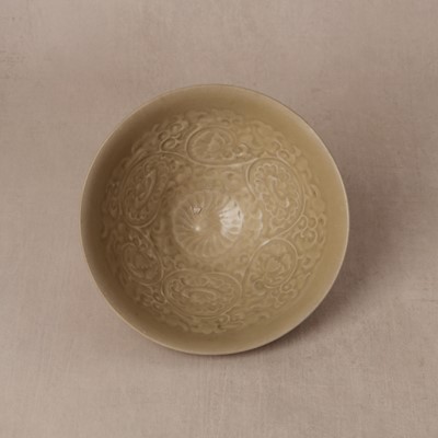 Lot 463 - A Chinese Yaozhou celadon 'lotus scroll' conical bowl, Song dynasty