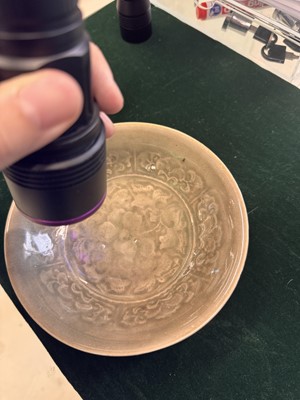 Lot 464 - A Chinese Yaozhou celadon 'peony' bowl, Northern Song dynasty