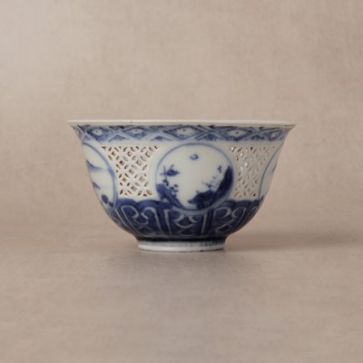 Lot 19 - A Chinese reticulated blue and white 'linglong' bowl, Qing dynasty, Ming dynasty, Chongzhen period