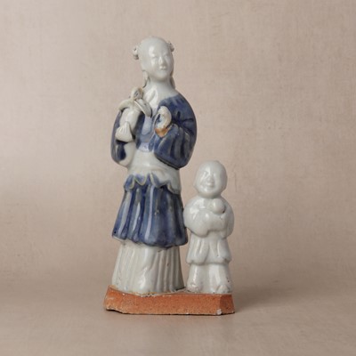 Lot 148 - A Chinese glazed-biscuit 'immortal and child' figure group, Qing dynasty, Qianlong period