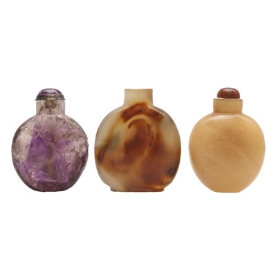 Lot 331 - A Chinese carved amethyst snuff bottle and two hardstone snuff bottles