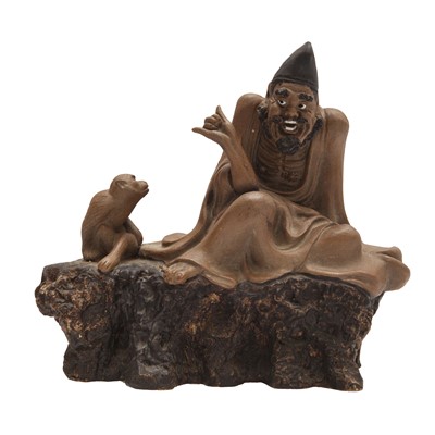 Lot 575 - A Chinese Shiwan 'man and monkey' figure group, 20th century