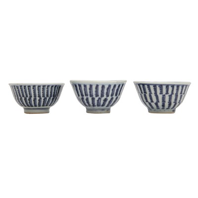 Lot 605 - Three Chinese blue and white 'sanskrit' cups, Qing dynasty, 18th/19th century