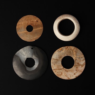 Lot 120 - Four Chinese archaistic jade and agate bi discs, 19th/20th century or earlier