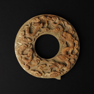 Lot 133 - A Chinese carved 'dragon' bi disc, Qing dynasty, 19th century