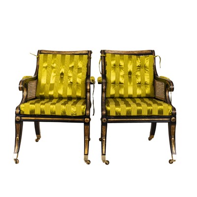 Lot 230 - A pair of Regency style ebonized and parcel-gilt armchairs