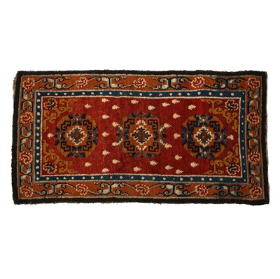 Lot 594 - A Tibetan 'floral' rectangular rug, 19th/20th century