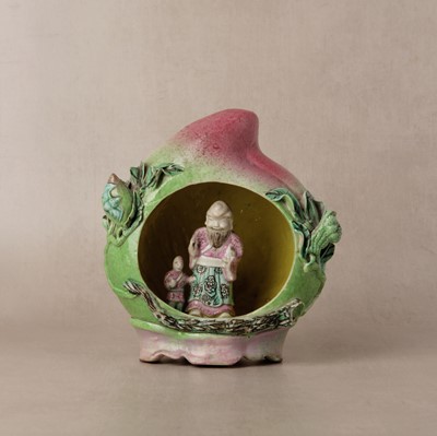 Lot 49 - A Chinese famille-rose 'shoulao' peach figure, Qing dynasty, 19th century