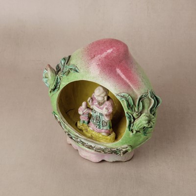 Lot 49 - A Chinese famille-rose 'shoulao' peach figure, Qing dynasty, 19th century