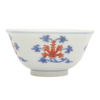 Lot 629 - A Chinese blue and white and copper-red 'Indian lotus' cup, 19th/20th century