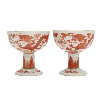 Lot 621 - A pair of Chinese iron-red 'dragon' stem cups, Qing dynasty, 19th century