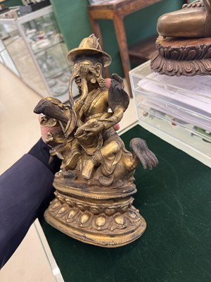 Lot 504 - A Tibetan bronze figure of Jambhala with consort, 20th century