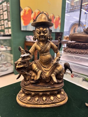 Lot 504 - A Tibetan bronze figure of Jambhala with consort, 20th century
