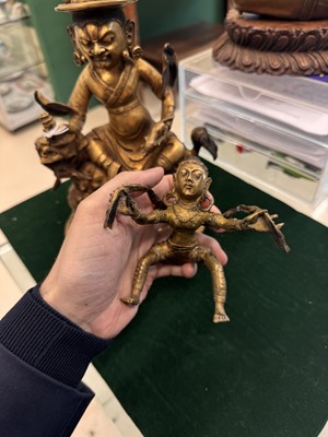 Lot 504 - A Tibetan bronze figure of Jambhala with consort, 20th century