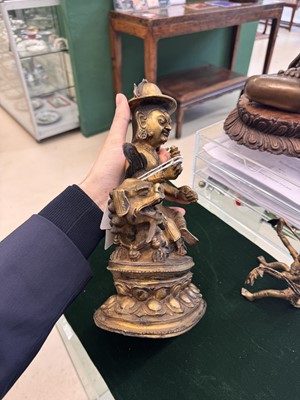 Lot 504 - A Tibetan bronze figure of Jambhala with consort, 20th century