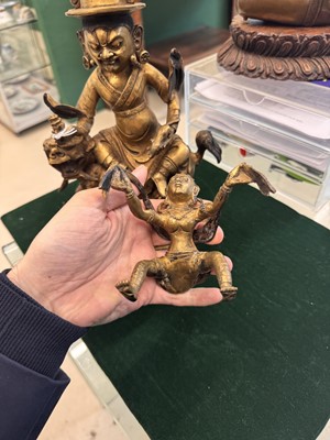 Lot 504 - A Tibetan bronze figure of Jambhala with consort, 20th century