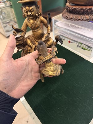 Lot 504 - A Tibetan bronze figure of Jambhala with consort, 20th century