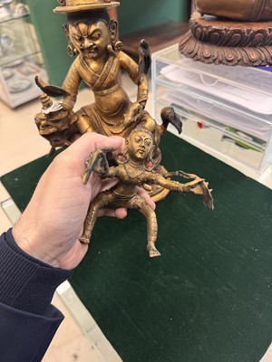 Lot 504 - A Tibetan bronze figure of Jambhala with consort, 20th century