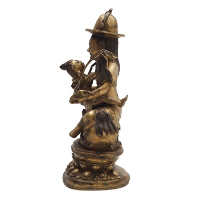 Lot 504 - A Tibetan bronze figure of Jambhala with consort, 20th century