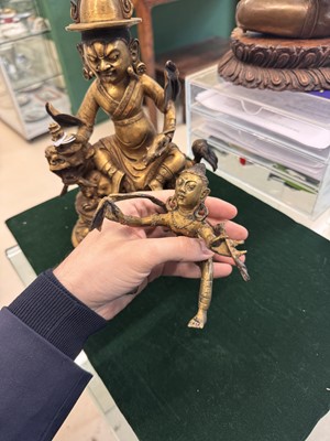 Lot 504 - A Tibetan bronze figure of Jambhala with consort, 20th century