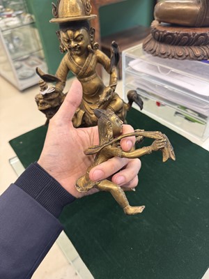 Lot 504 - A Tibetan bronze figure of Jambhala with consort, 20th century