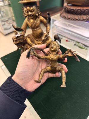 Lot 504 - A Tibetan bronze figure of Jambhala with consort, 20th century