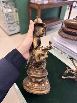 Lot 504 - A Tibetan bronze figure of Jambhala with consort, 20th century