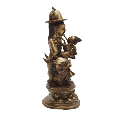 Lot 504 - A Tibetan bronze figure of Jambhala with consort, 20th century