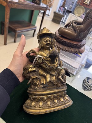 Lot 504 - A Tibetan bronze figure of Jambhala with consort, 20th century