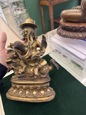 Lot 504 - A Tibetan bronze figure of Jambhala with consort, 20th century