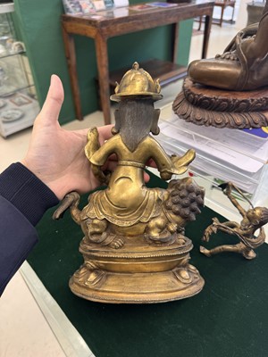 Lot 504 - A Tibetan bronze figure of Jambhala with consort, 20th century