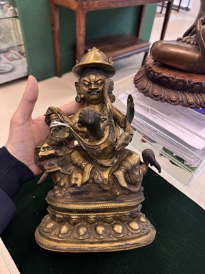Lot 504 - A Tibetan bronze figure of Jambhala with consort, 20th century