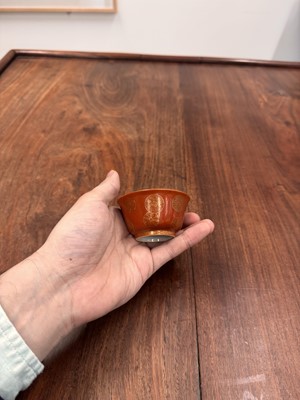 Lot 79 - A pair of Chinese coral-ground gilt-decorated cups, Qing dynasty, Yongzheng marks