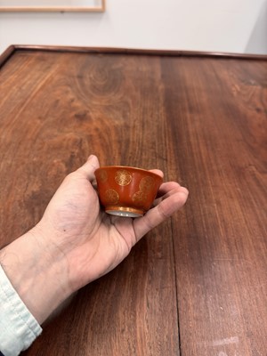Lot 79 - A pair of Chinese coral-ground gilt-decorated cups, Qing dynasty, Yongzheng marks