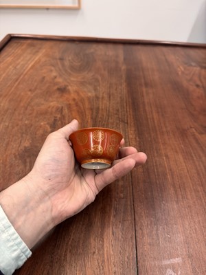 Lot 79 - A pair of Chinese coral-ground gilt-decorated cups, Qing dynasty, Yongzheng marks