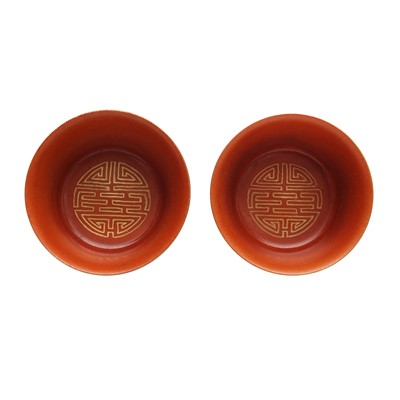 Lot 79 - A pair of Chinese coral-ground gilt-decorated cups, Qing dynasty, Yongzheng marks
