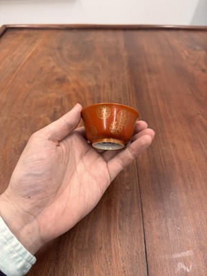 Lot 79 - A pair of Chinese coral-ground gilt-decorated cups, Qing dynasty, Yongzheng marks