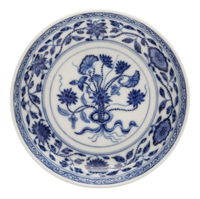 Lot 54 - A Chinese Ming-style blue and white 'lotus bouquet' saucer, Qing dynasty, Daoguang mark and of the period