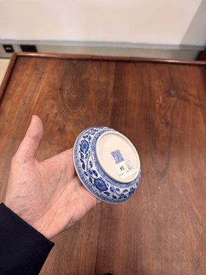 Lot 54 - A Chinese Ming-style blue and white 'lotus bouquet' saucer, Qing dynasty, Daoguang mark and of the period