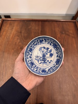 Lot 54 - A Chinese Ming-style blue and white 'lotus bouquet' saucer, Qing dynasty, Daoguang mark and of the period