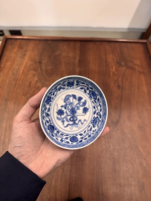 Lot 54 - A Chinese Ming-style blue and white 'lotus bouquet' saucer, Qing dynasty, Daoguang mark and of the period
