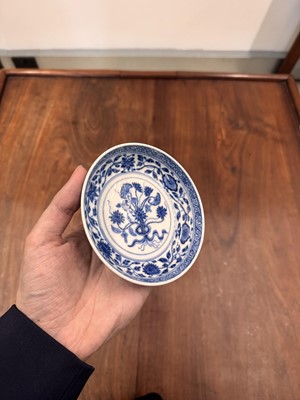 Lot 54 - A Chinese Ming-style blue and white 'lotus bouquet' saucer, Qing dynasty, Daoguang mark and of the period